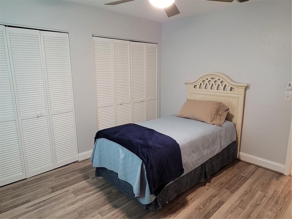 14447 Worthwhile Road Port Charlotte, FL 33953 - Photo 10 of 23 a bedroom with a bed and wooden floor