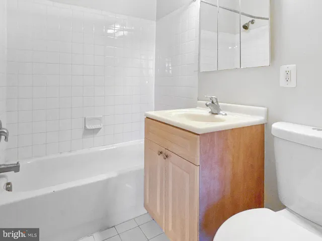 a bathroom with a sink a toilet and bathtub