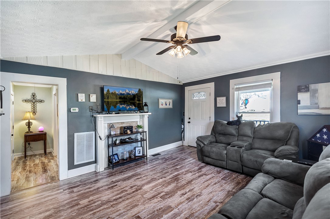 11 Jackson Street Liberty, SC 29657 - Photo 9 of 27 This living area features ample natural light and a decorative fireplace for cozy gatherings.