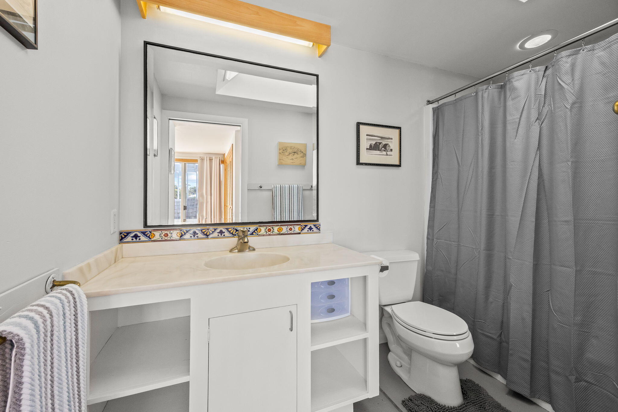2 Cobb Road Truro, MA 02666 - Photo 18 of 38 a bathroom with a sink a toilet and a mirror