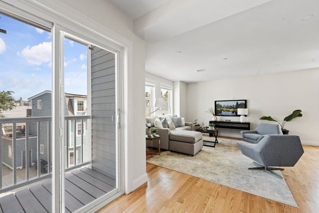 a living room with furniture and a painting on the wall