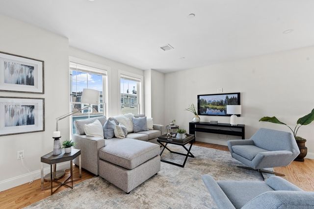 a view of a bedroom with a bed and wooden floor