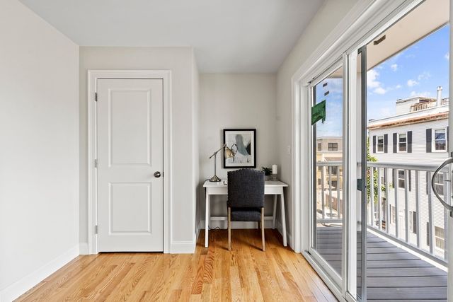 a living room with furniture flat screen tv and a large window