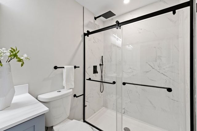 a bathroom with a shower and toilet