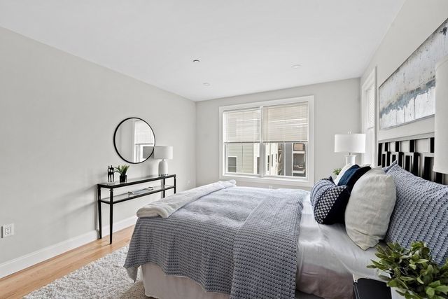 a bathroom with a sink a mirror a vanity and shower