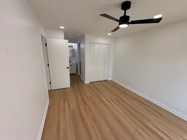 a view of empty room with wooden floor