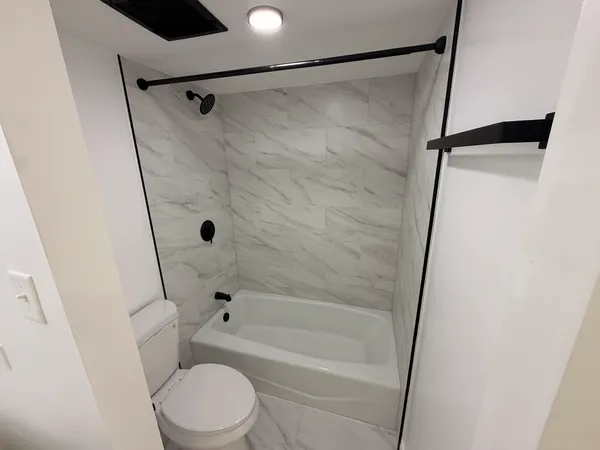 a bathroom with a toilet and a shower