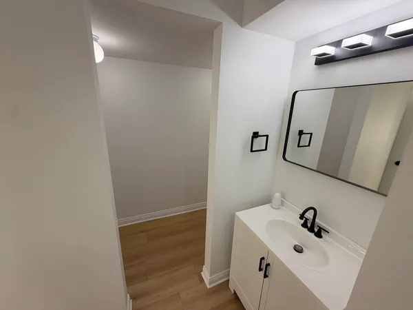 a bathroom with a sink and mirror
