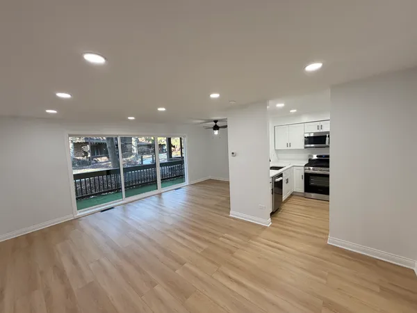 a view of kitchen with cabinets and wooden floor