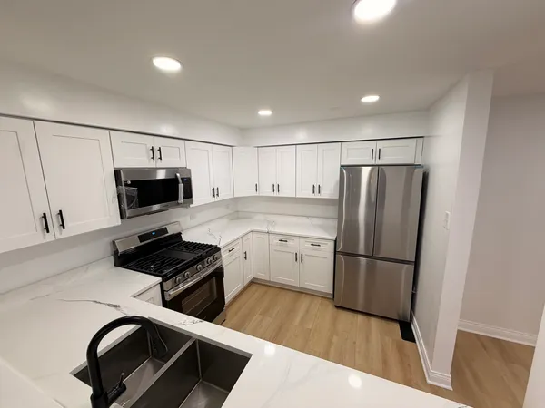 a kitchen with a refrigerator and a sink