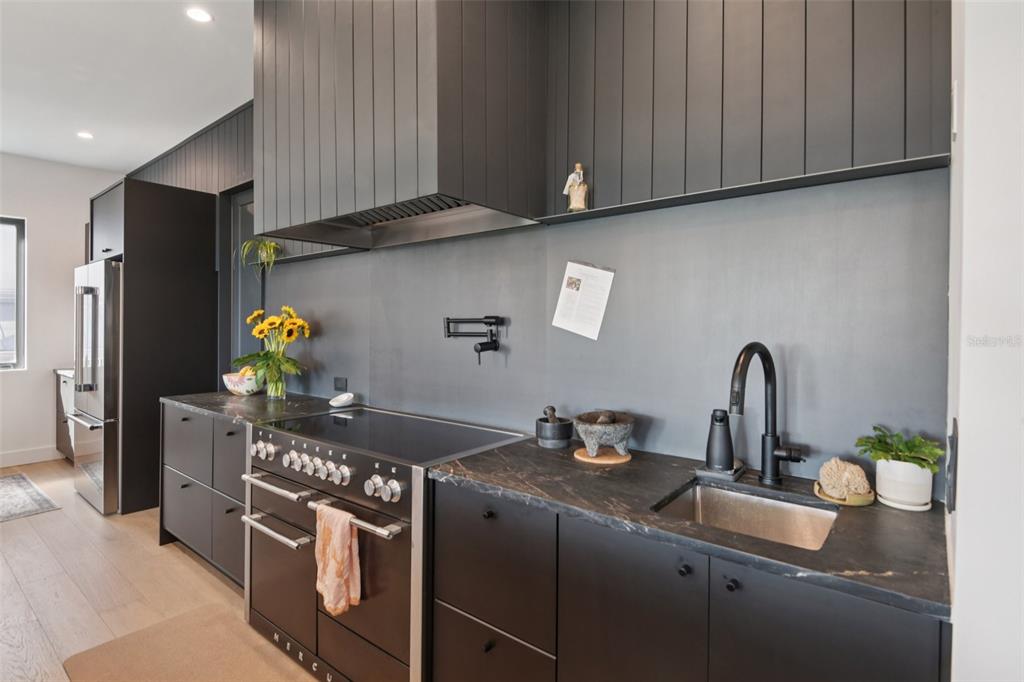 4828 West Flamingo Road Tampa, FL 33611 - Photo 16 of 67 a kitchen with stainless steel appliances granite countertop a sink a stove and a refrigerator