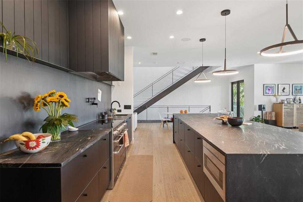 4828 West Flamingo Road Tampa, FL 33611 - Photo 17 of 67 a kitchen with stainless steel appliances granite countertop a sink a stove and a wooden floor