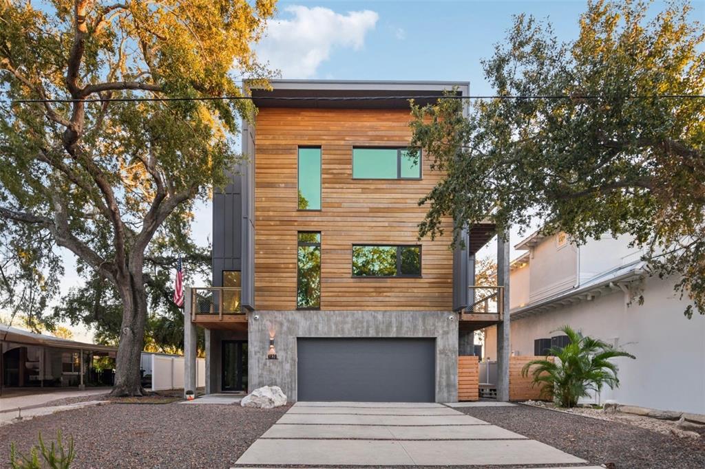 4828 West Flamingo Road Tampa, FL 33611 - Photo 2 of 67 a front view of a house with a garden