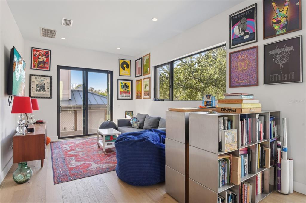 4828 West Flamingo Road Tampa, FL 33611 - Photo 26 of 67 a living room with furniture cabinets and a large window