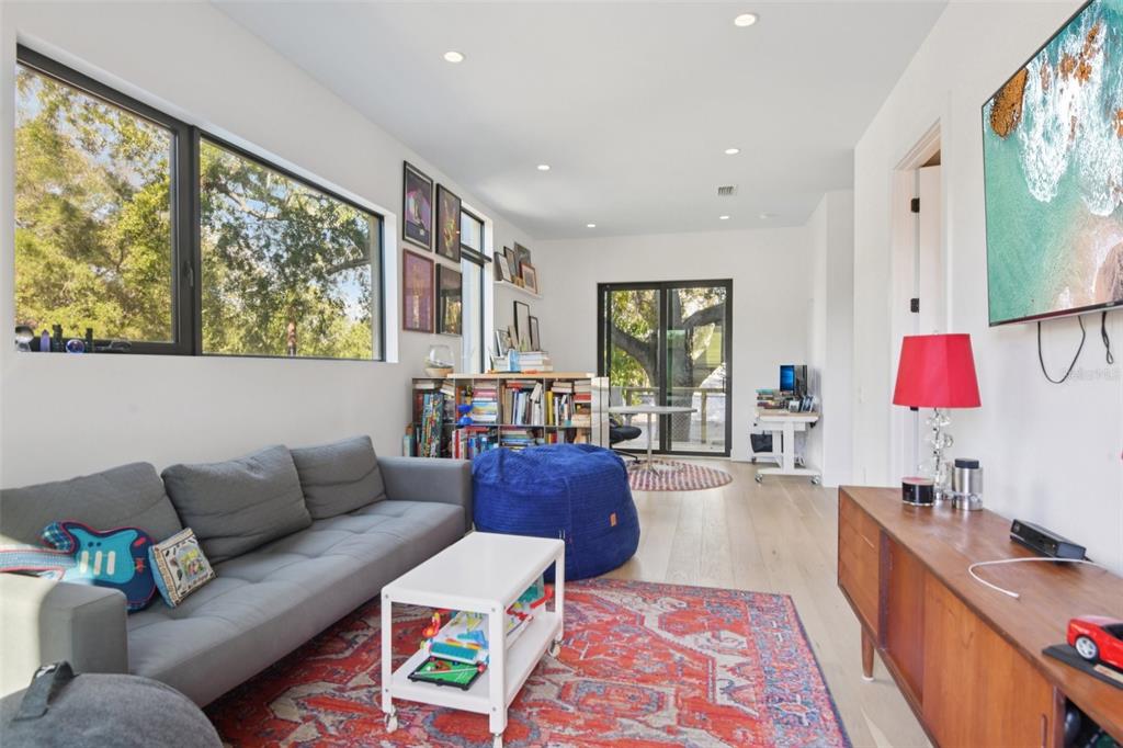 4828 West Flamingo Road Tampa, FL 33611 - Photo 27 of 67 a living room with furniture and a flat screen tv