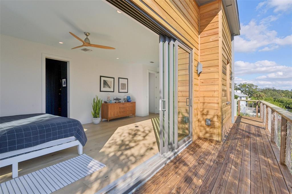 4828 West Flamingo Road Tampa, FL 33611 - Photo 33 of 67 a bedroom with a bed and wooden floor