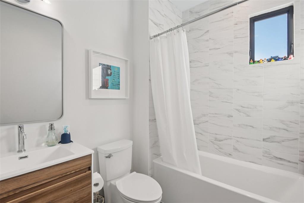 4828 West Flamingo Road Tampa, FL 33611 - Photo 43 of 67 a bathroom with a sink toilet and shower