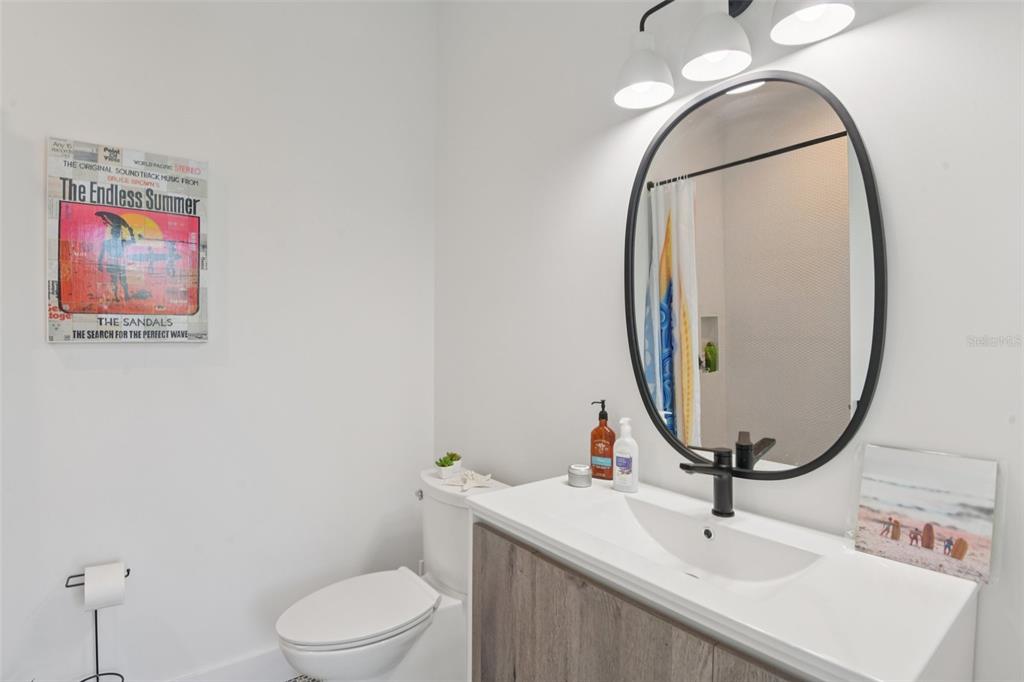 4828 West Flamingo Road Tampa, FL 33611 - Photo 44 of 67 a bathroom with a sink a toilet and a mirror