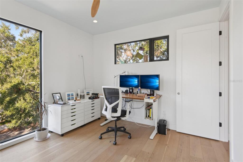 4828 West Flamingo Road Tampa, FL 33611 - Photo 46 of 67 a view of a workspace with furniture and a window