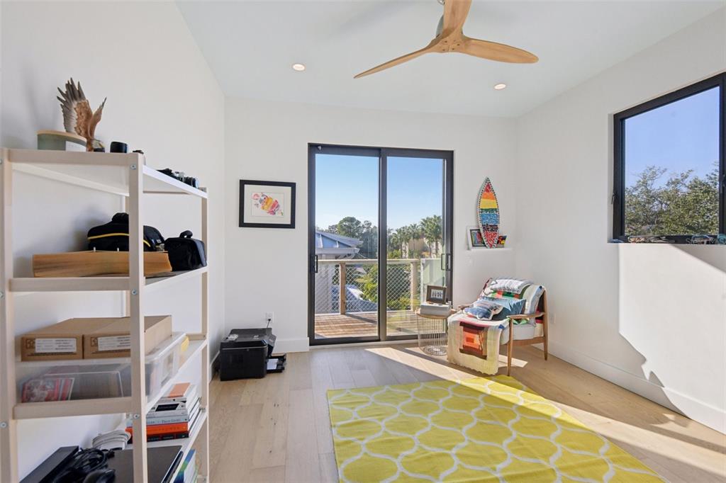 4828 West Flamingo Road Tampa, FL 33611 - Photo 47 of 67 a bedroom with furniture and a floor to ceiling window