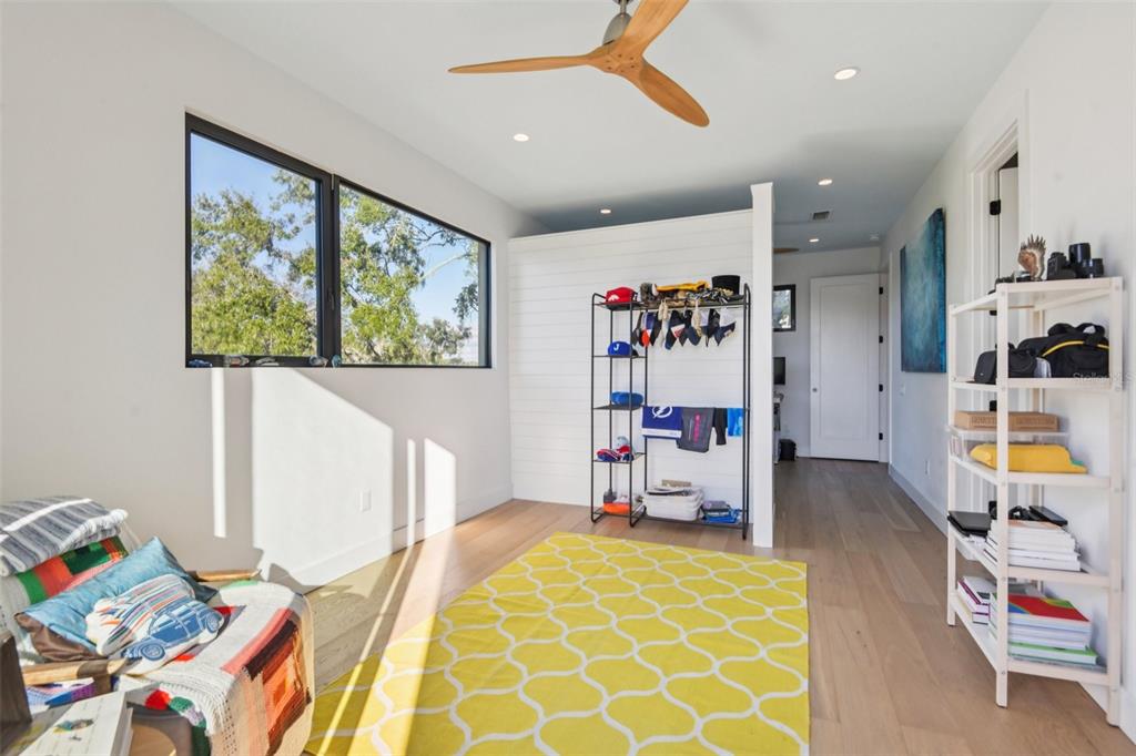 4828 West Flamingo Road Tampa, FL 33611 - Photo 48 of 67 a bed room with a bed and a book shelf