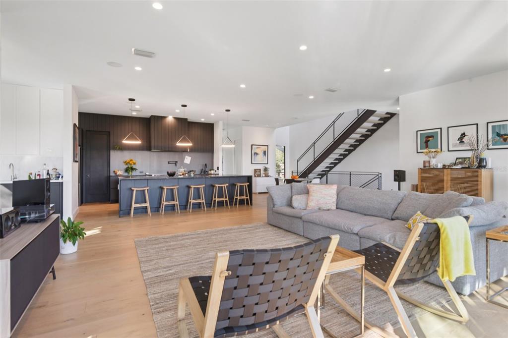 4828 West Flamingo Road Tampa, FL 33611 - Photo 5 of 67 a living room with furniture and kitchen view with wooden floor