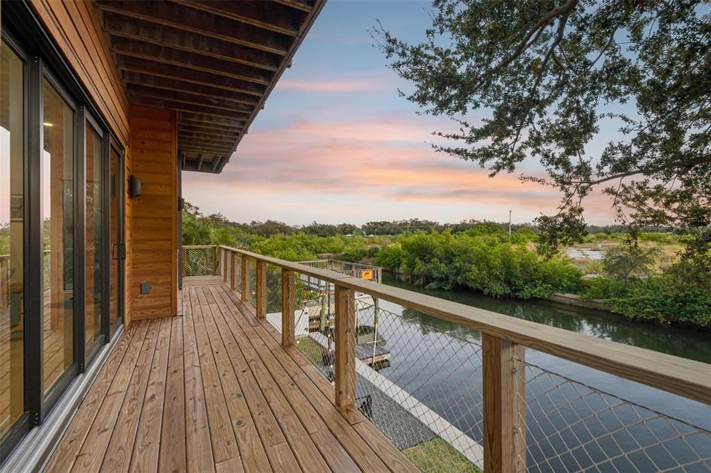4828 West Flamingo Road Tampa, FL 33611 - Photo 7 of 67 a view of balcony with wooden floor and fence