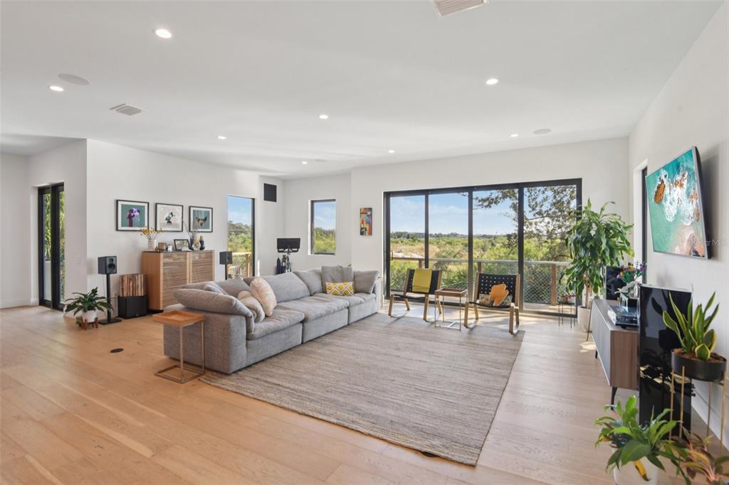 4828 West Flamingo Road Tampa, FL 33611 - Photo 9 of 67 a living room with furniture floor to ceiling window and potted plant