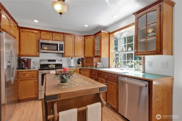 a kitchen that has a sink and a stove top oven