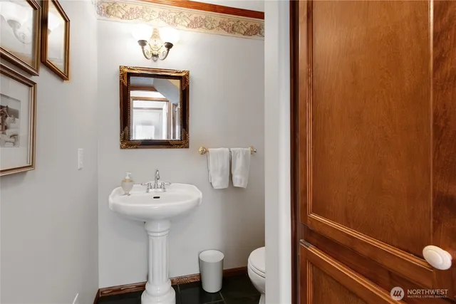 a bathroom with a sink toilet and mirror