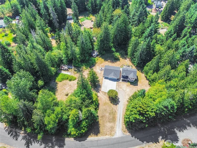 an aerial view of a house with a yard and garden