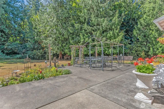 a view of a patio with plants and a garden