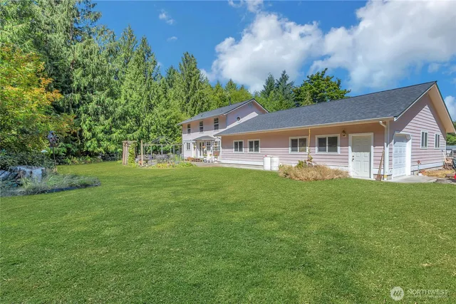 a aerial view of a house with a yard table and chairs