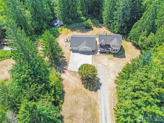 an aerial view of a house with a yard