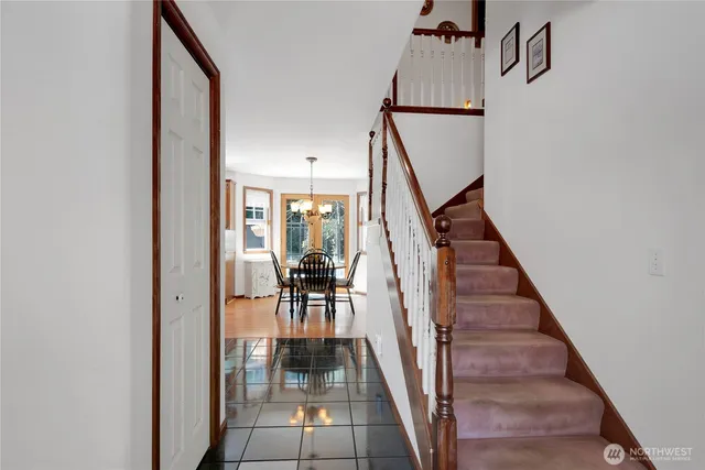 a view of entryway and hall with wooden floor