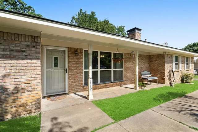 a front view of a house with a garden and porch