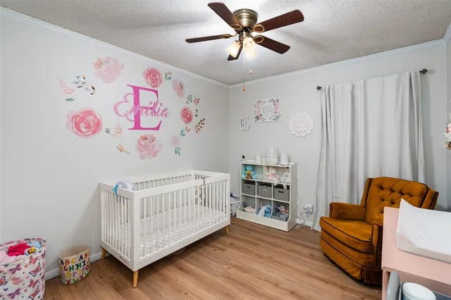 a bedroom with furniture and wooden floor