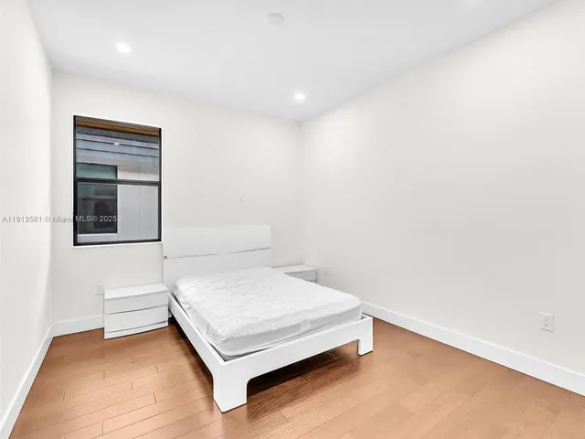 a bedroom with a bed and cabinets