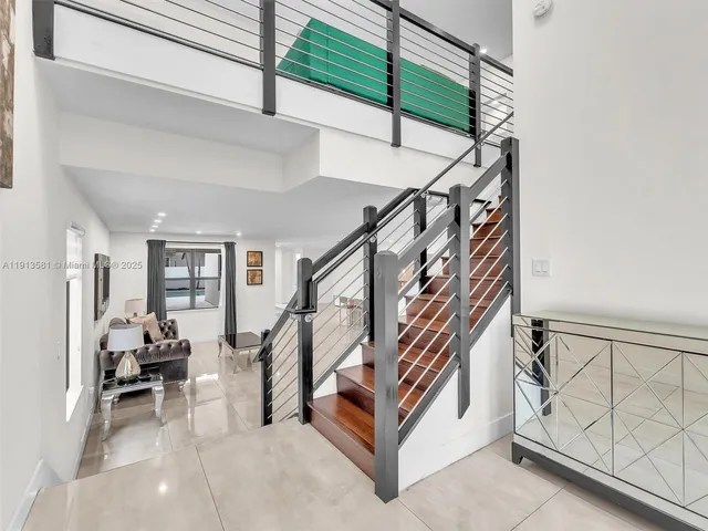 a view of entryway with furniture and stairs