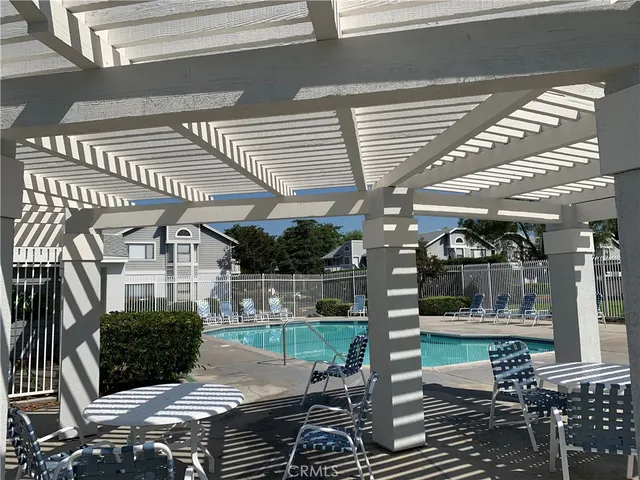 a view of a porch with chairs and potted plants
