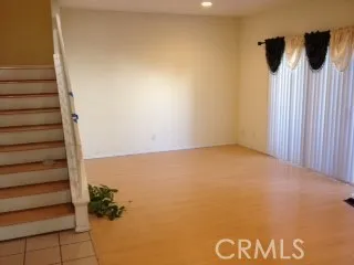a view of a room with wooden floor and windows