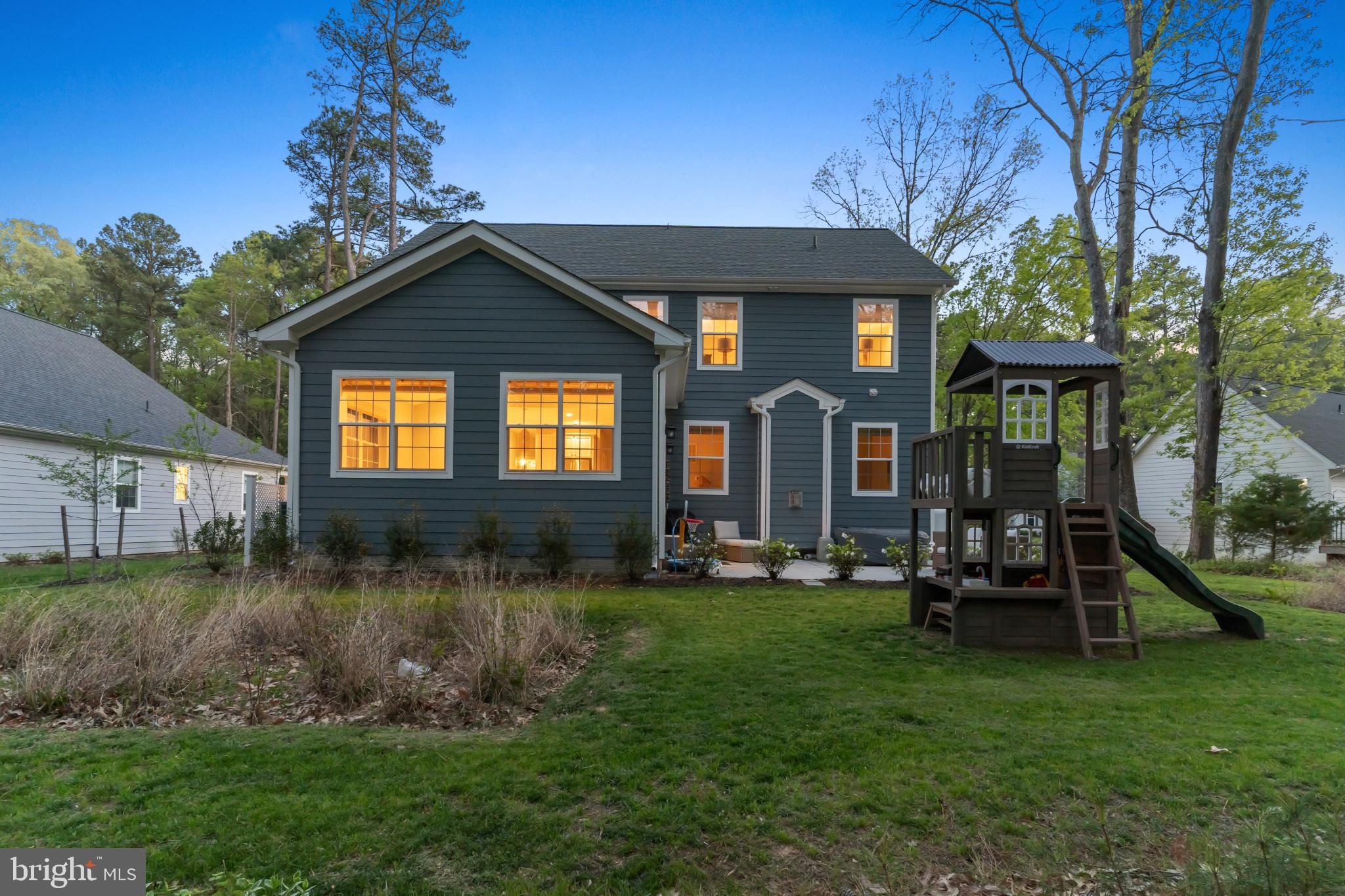14720 Locust Court Issue, MD 20645 - Photo 35 of 42 a front view of a house with a yard table and chairs