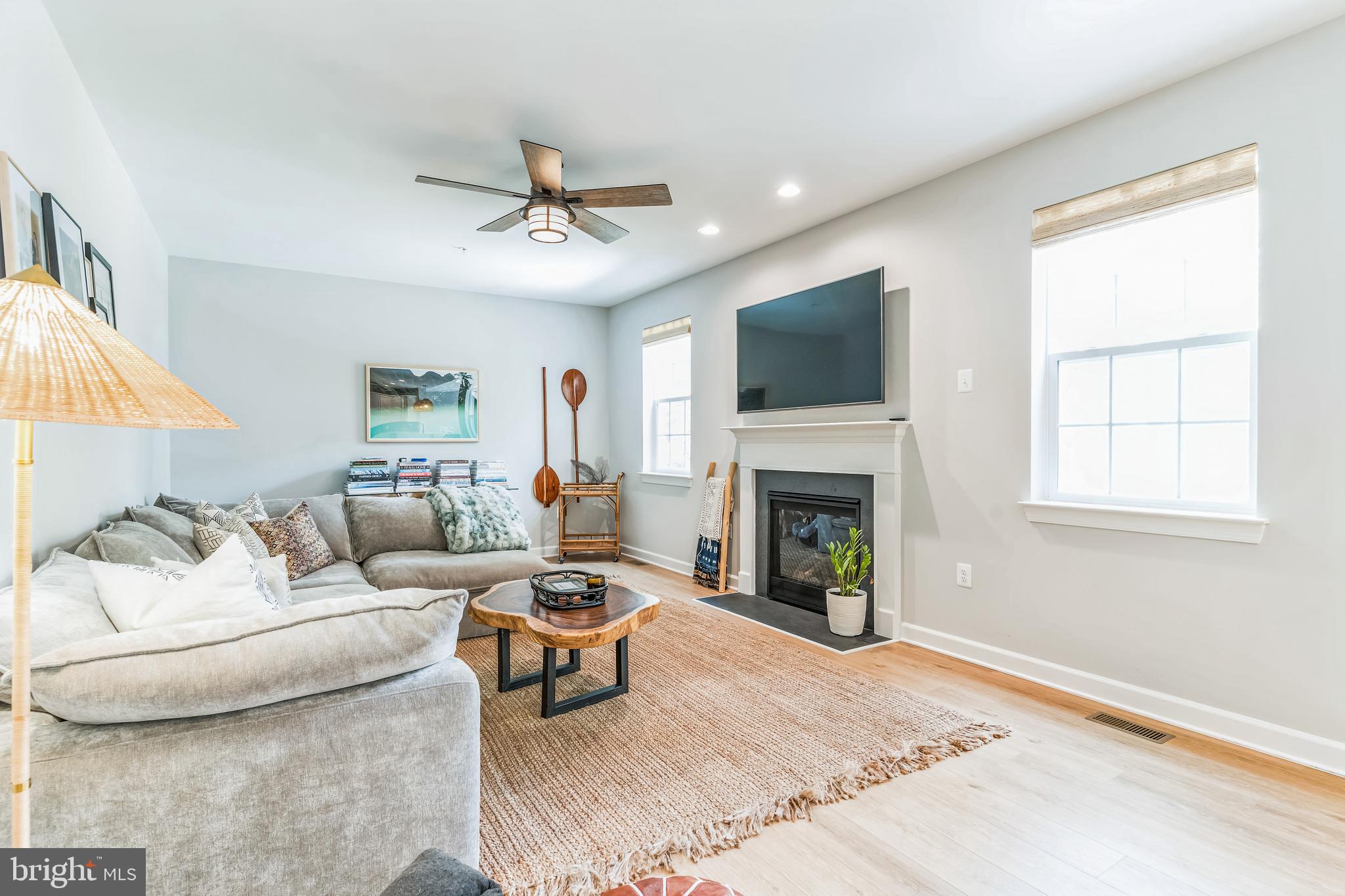 14720 Locust Court Issue, MD 20645 - Photo 5 of 42 a living room with furniture a fireplace and a flat screen tv