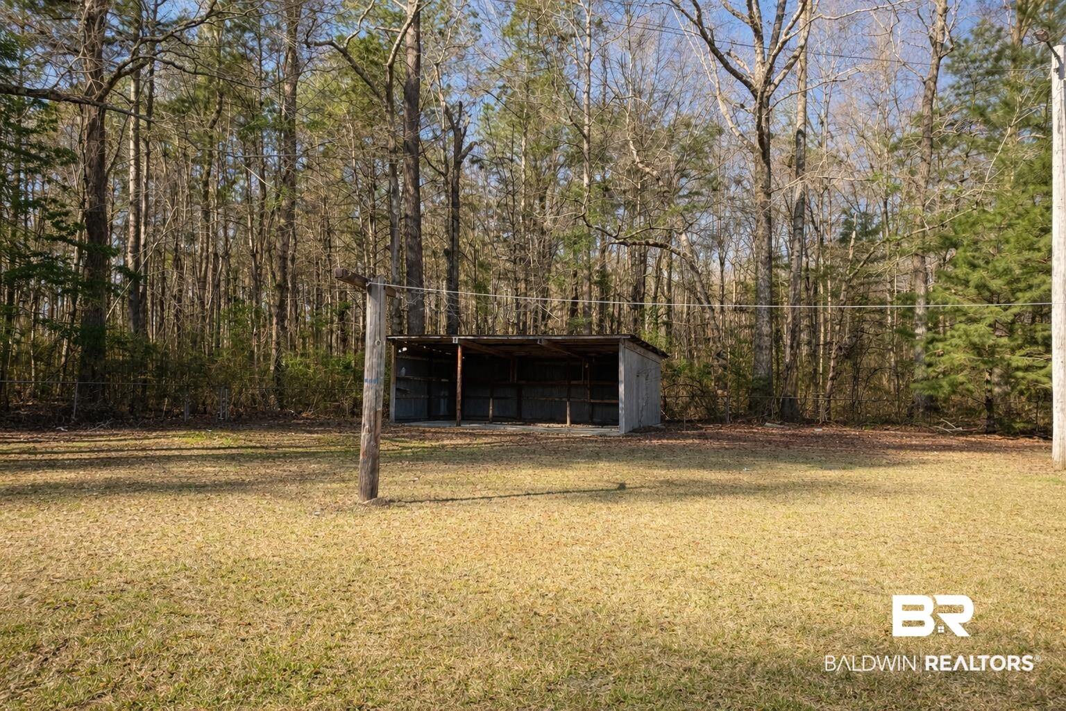 98 Evans Avenue Brewton, AL 36426 - Photo 17 of 18 View of pole building with a yard and a detached carport
