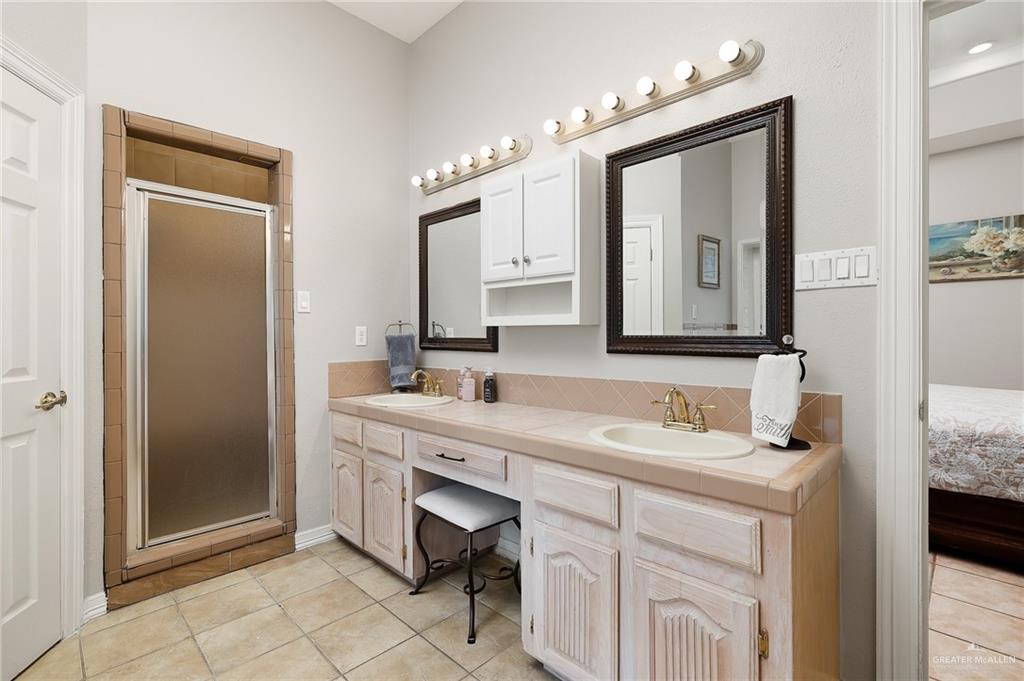 5344 East Mile 4 Road Mission, TX 78573 - Photo 12 of 22 a bathroom with a double vanity sink mirror and