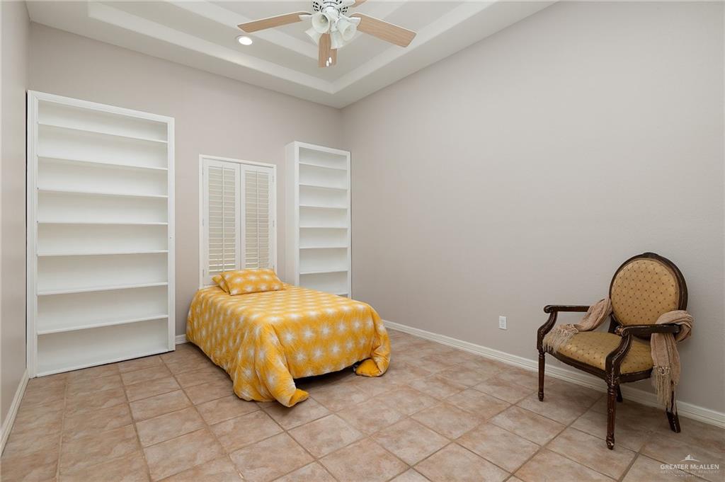5344 East Mile 4 Road Mission, TX 78573 - Photo 13 of 22 a room with a bed and a chandelier