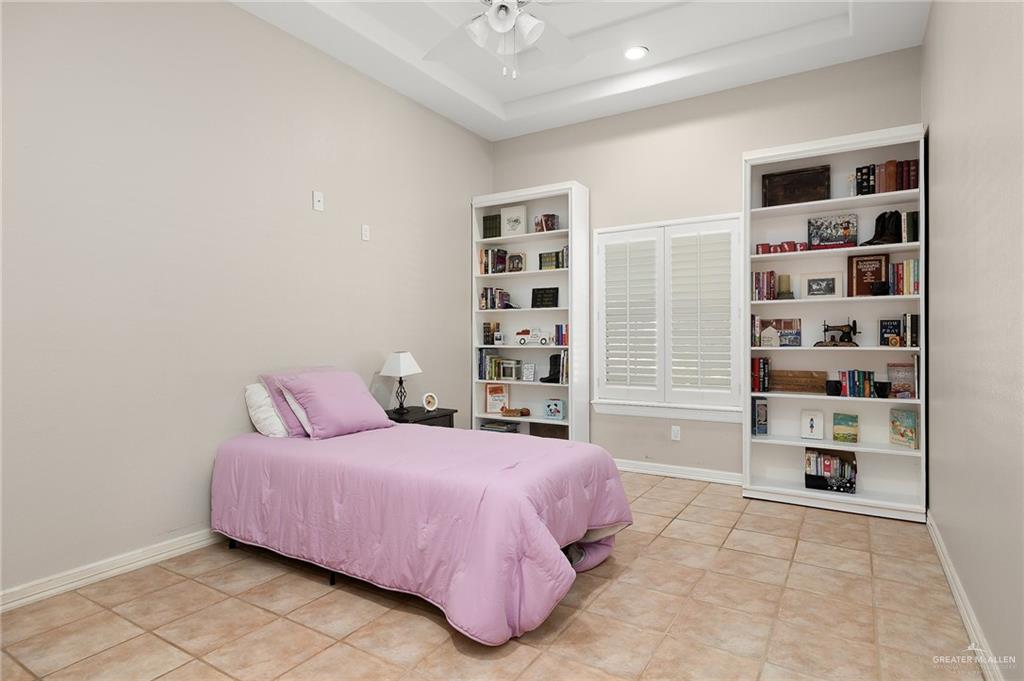 5344 East Mile 4 Road Mission, TX 78573 - Photo 14 of 22 a bedroom with a bed cabinets and a window