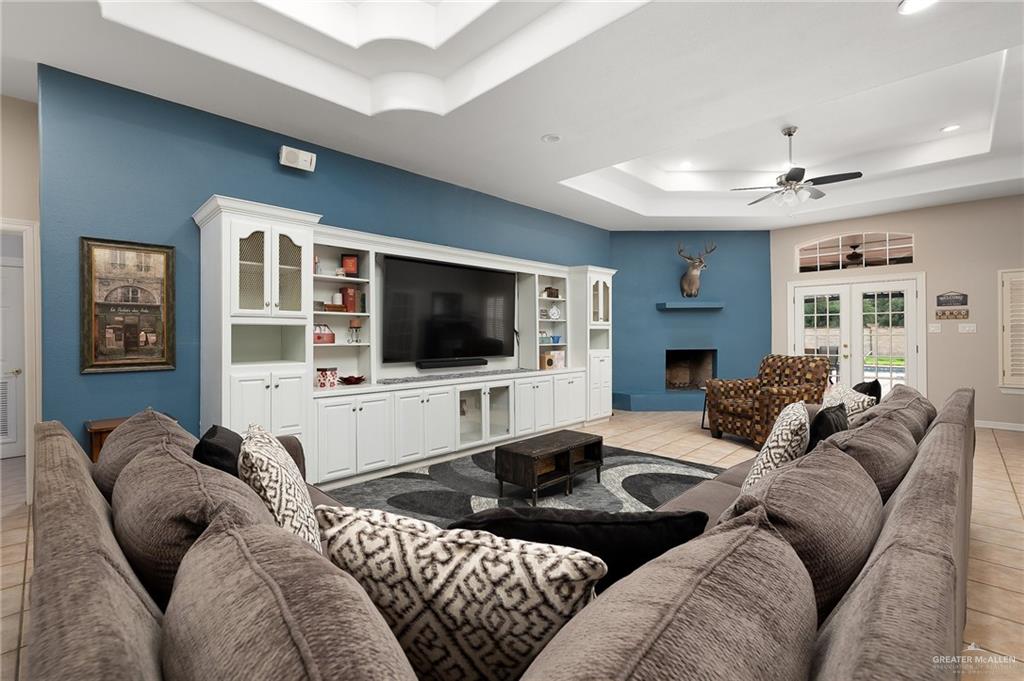 5344 East Mile 4 Road Mission, TX 78573 - Photo 5 of 22 a living room with furniture and a flat screen tv