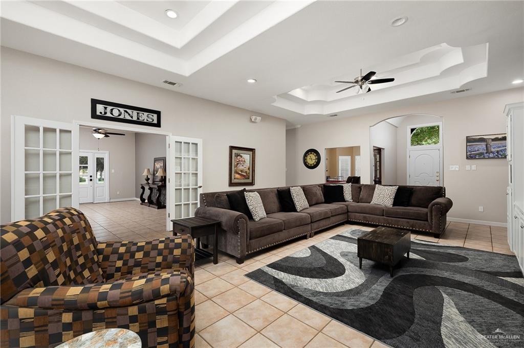 5344 East Mile 4 Road Mission, TX 78573 - Photo 7 of 22 a living room with furniture ceiling fan and a rug