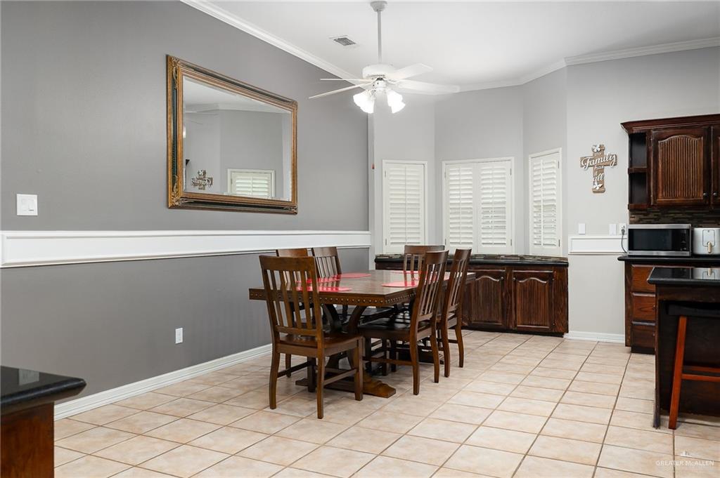 5344 East Mile 4 Road Mission, TX 78573 - Photo 10 of 22 a view of a dining room with furniture